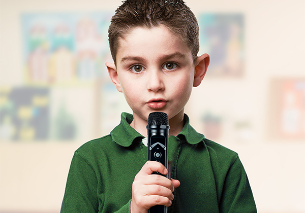 Young student using Redcat soundfield technology in the form of a microphone